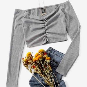 size XS. US size 2. Light grey, Off the shoulder, long sleeved crop top.